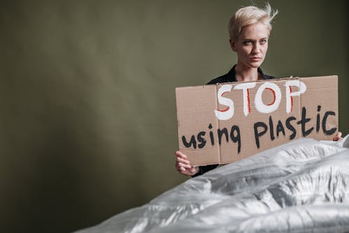 A Short Haired Woman Holding a Placard