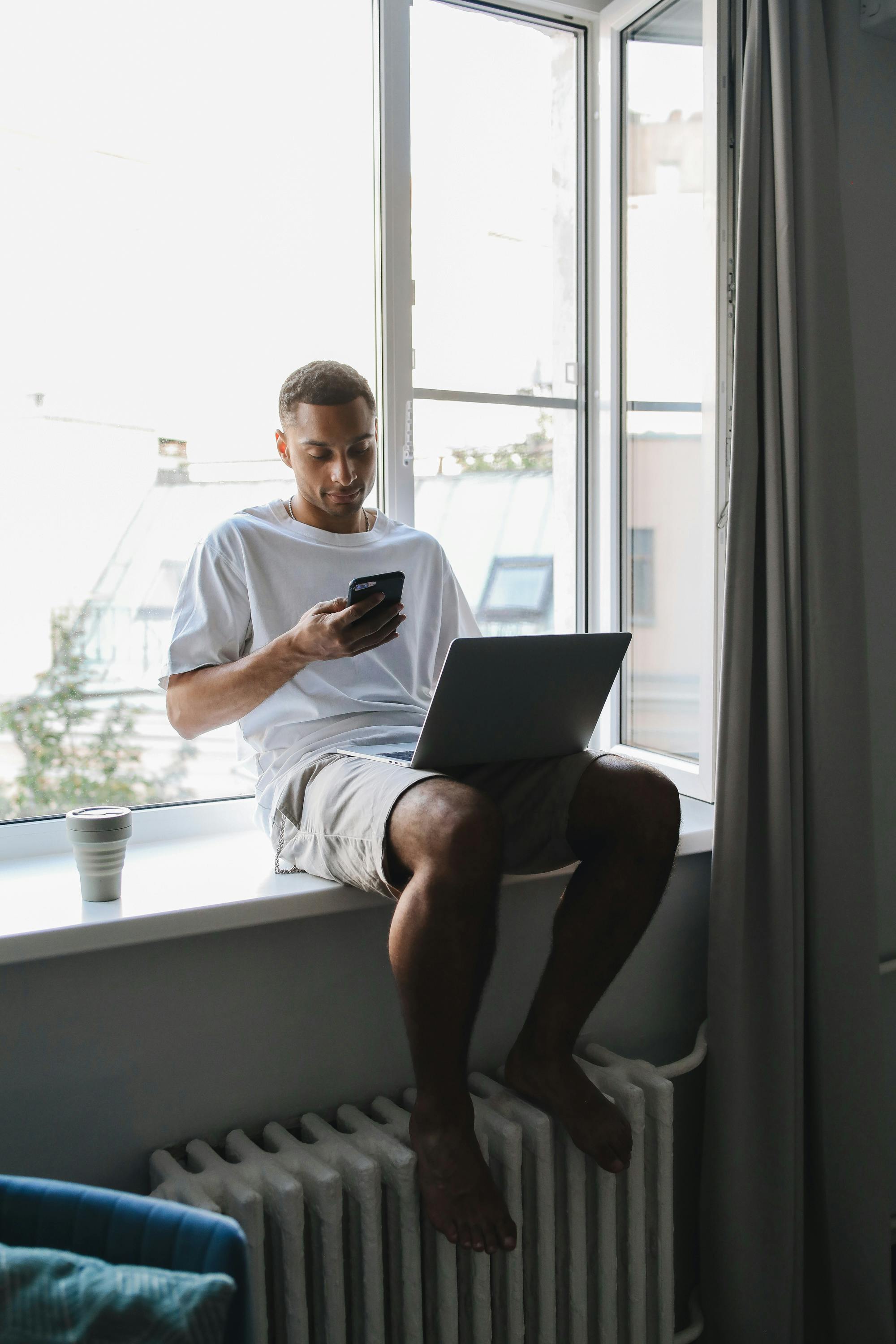 man sitting beside a window