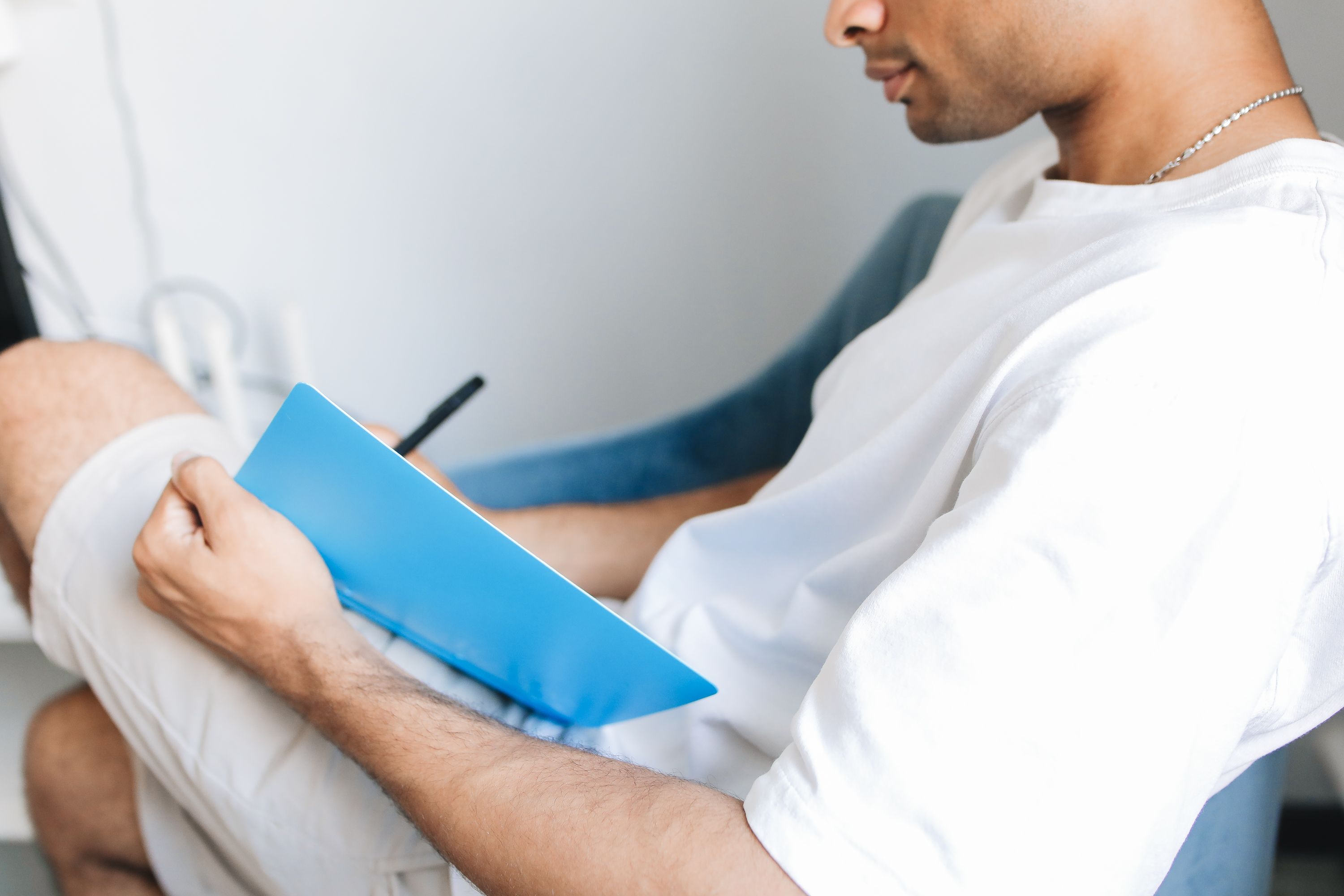 A person journaling with a pen and notebook, focusing on identifying personal triggers for mental health relapse - mental health relapse prevention strategies
