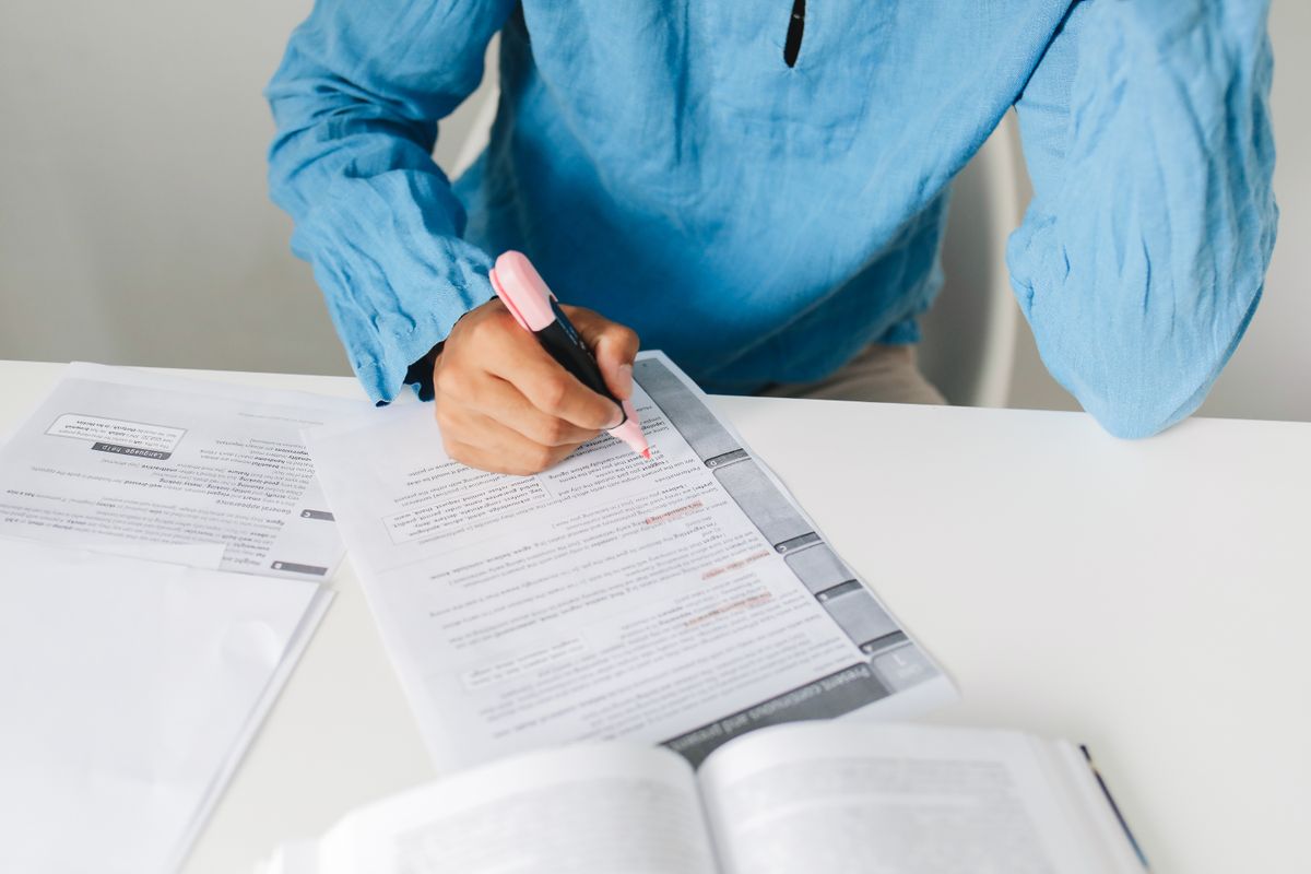 Person studying Spanish vocabulary with books and notes