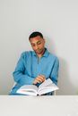 Man in Blue Dress Shirt Sitting on Blue Chair