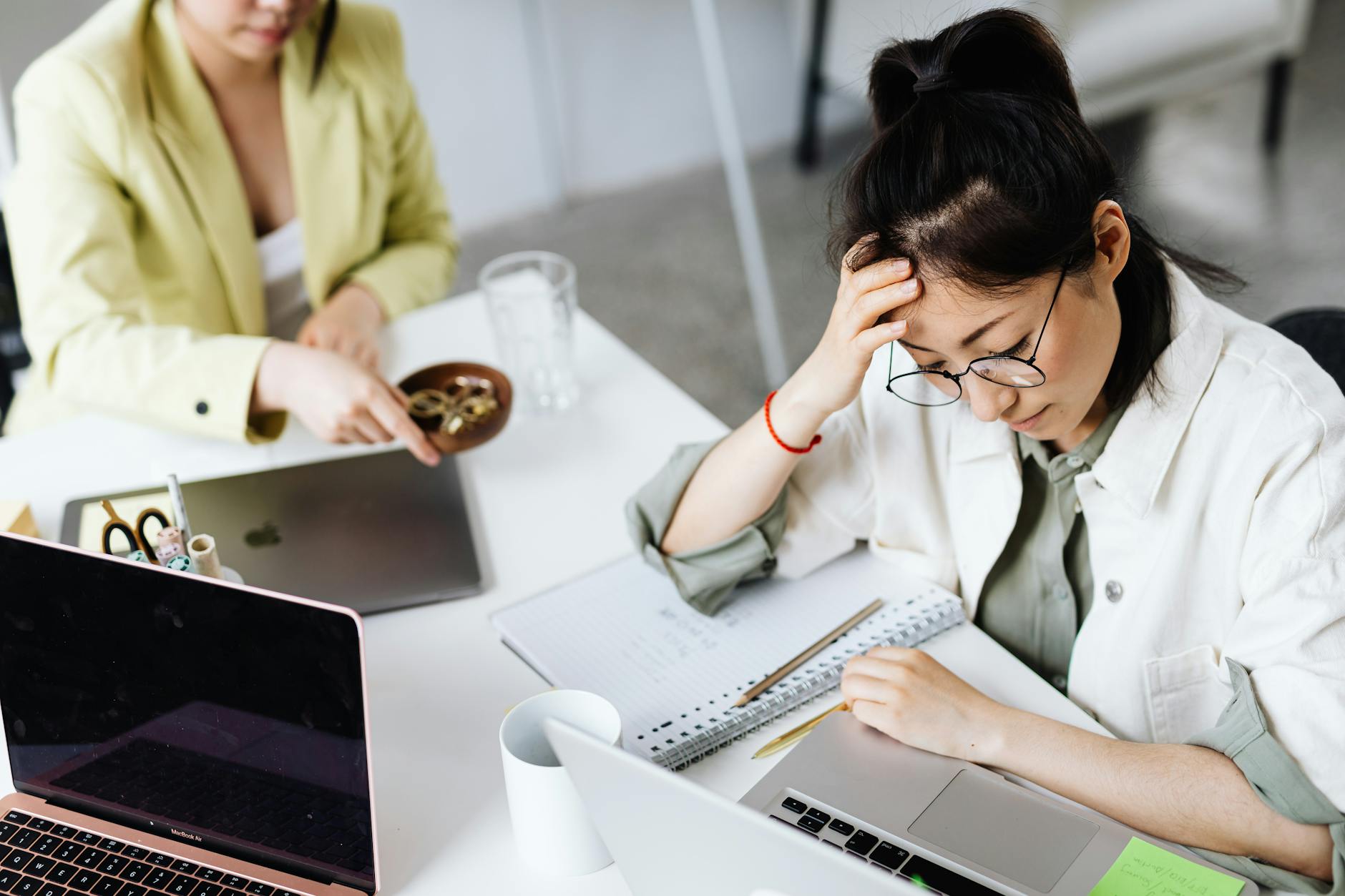 Woman looking stressed while working on laptop