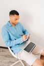 Man in Blue Dress Shirt Using Macbook Air