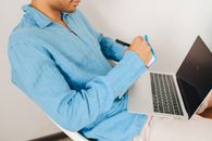 Man in Blue Dress Shirt Using Macbook Pro