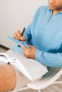 Person in Blue Denim Jeans Holding Black Pen Writing on White Paper