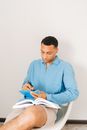 Man in Blue Dress Shirt Reading Book