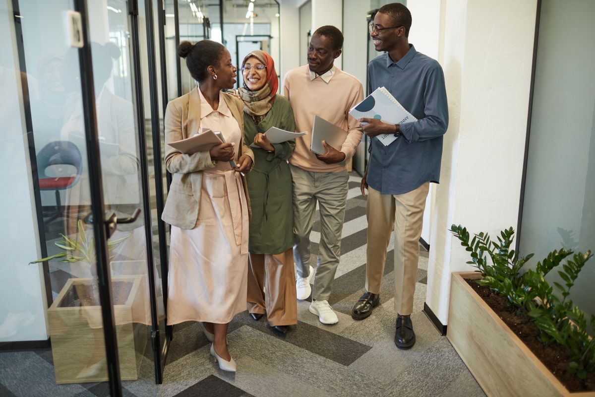 People walking in a modern office hallway