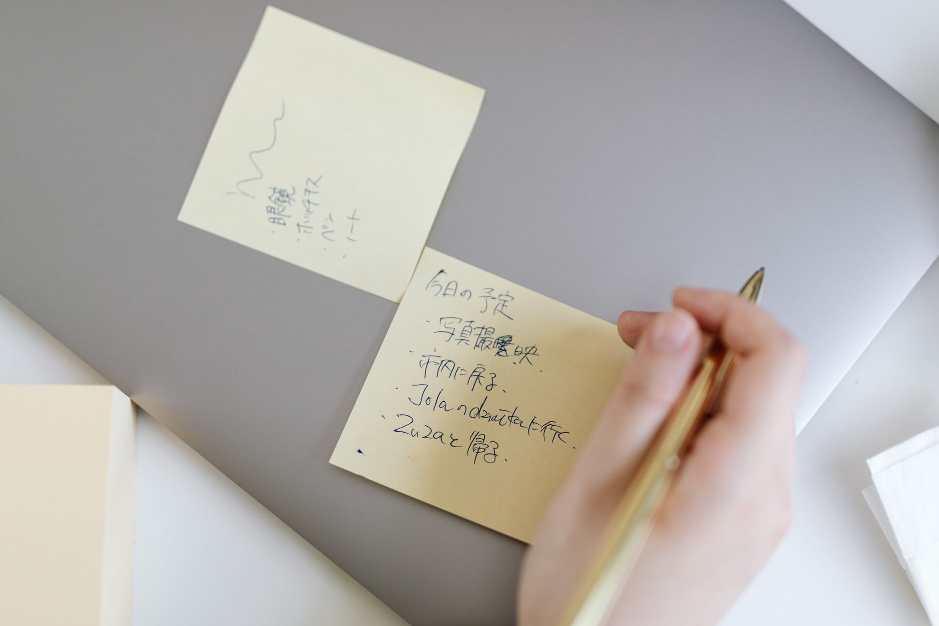 Planner notes and laptop used to draft image alt text for blog posts