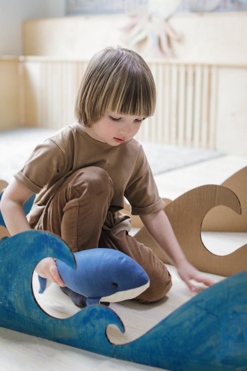 Photograph of a Boy Playing with a Toy Shark