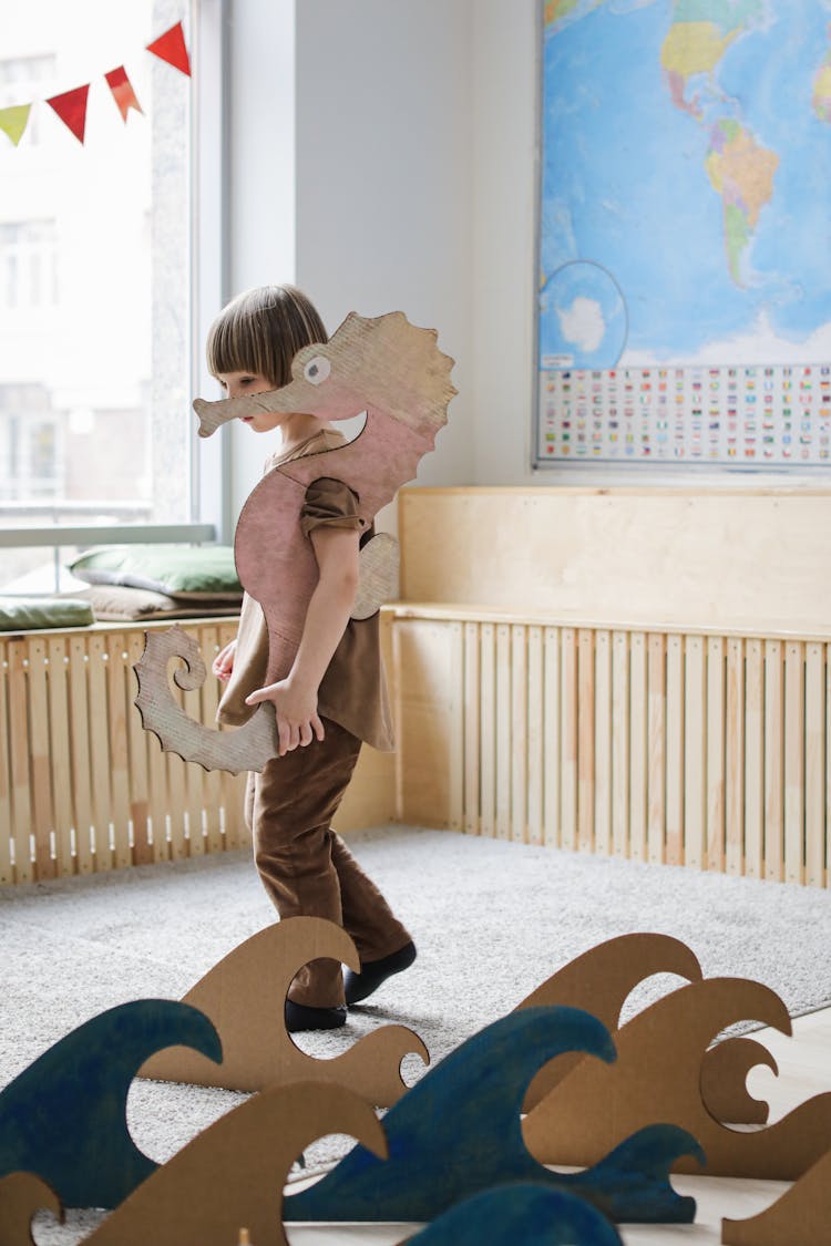 A Young Boy Wearing Cardboard Seahorse