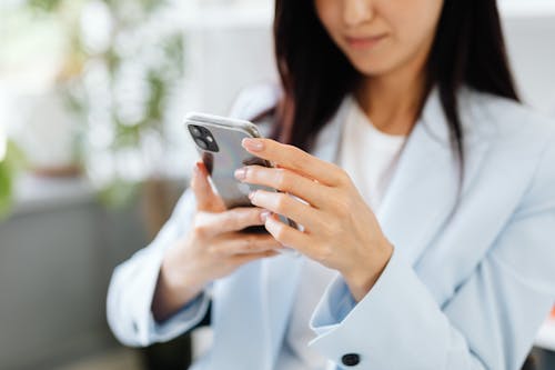 Free Woman Browsing Her Smartphone Stock Photo