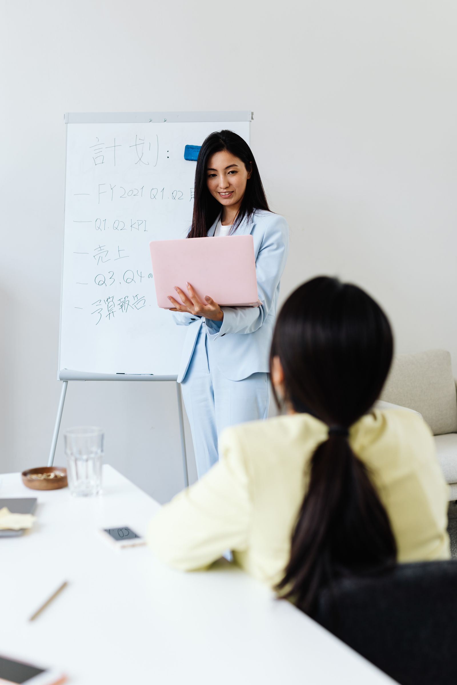 A founder at the whiteboard while the operation still routes through her
