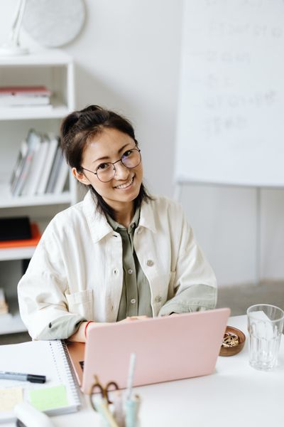 Local government clerk managing agenda software on laptop