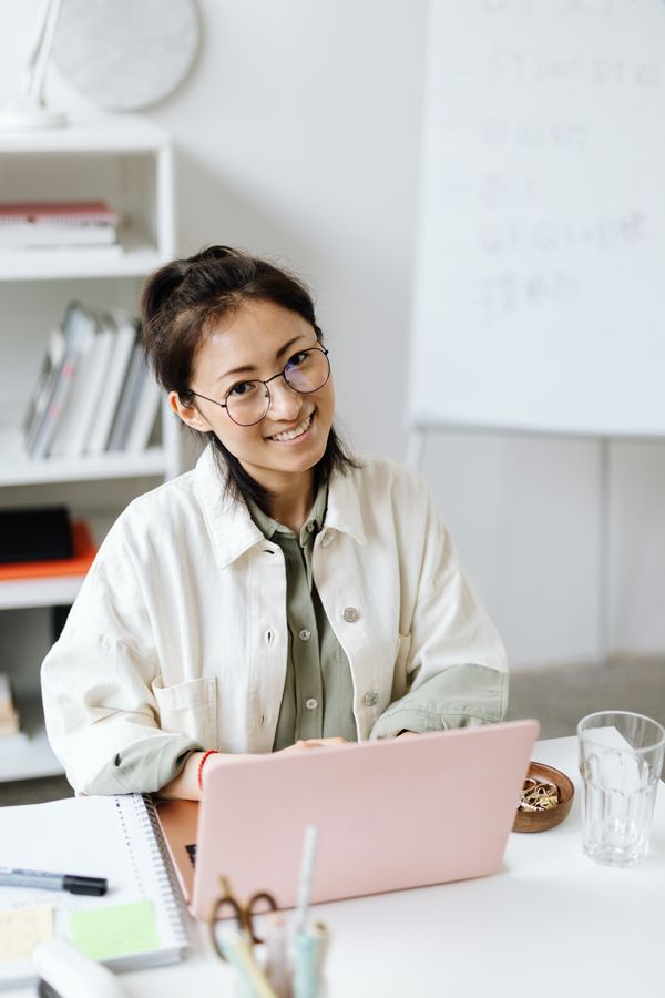 Local government clerk managing agenda software on laptop