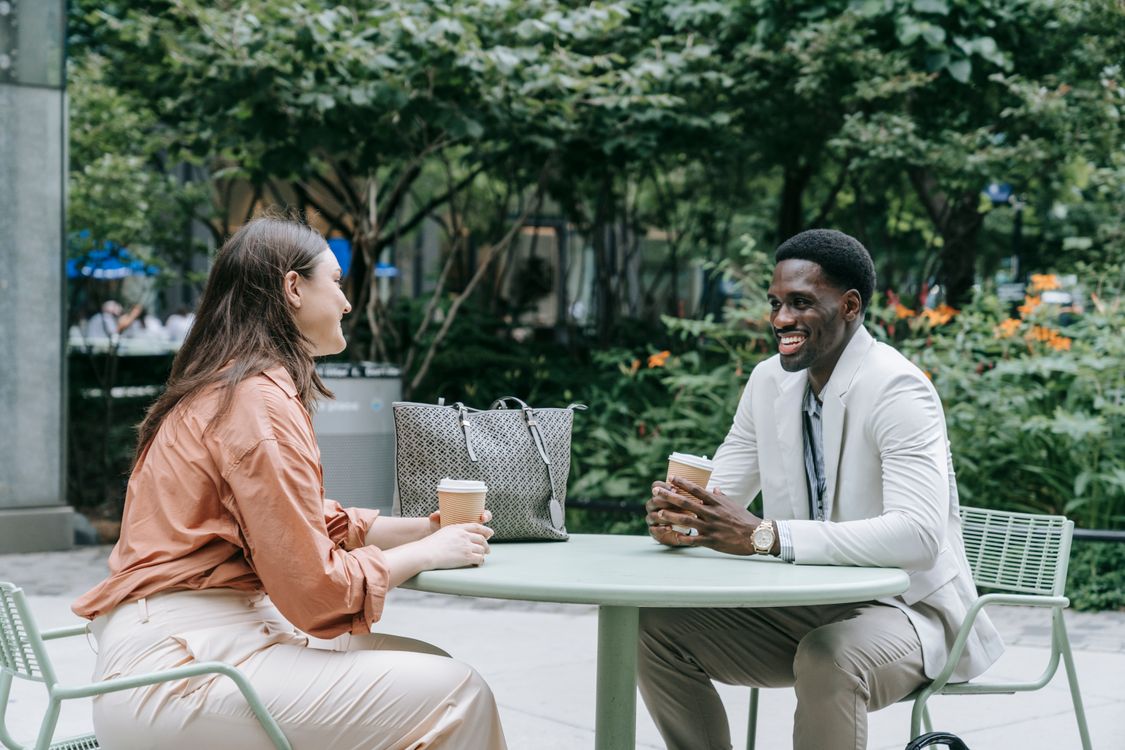 Two people talking at a café table