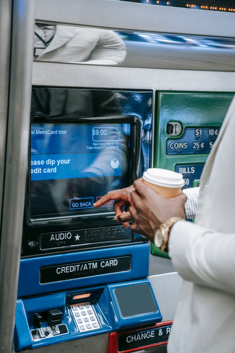 Person Using An Automated Teller Machine