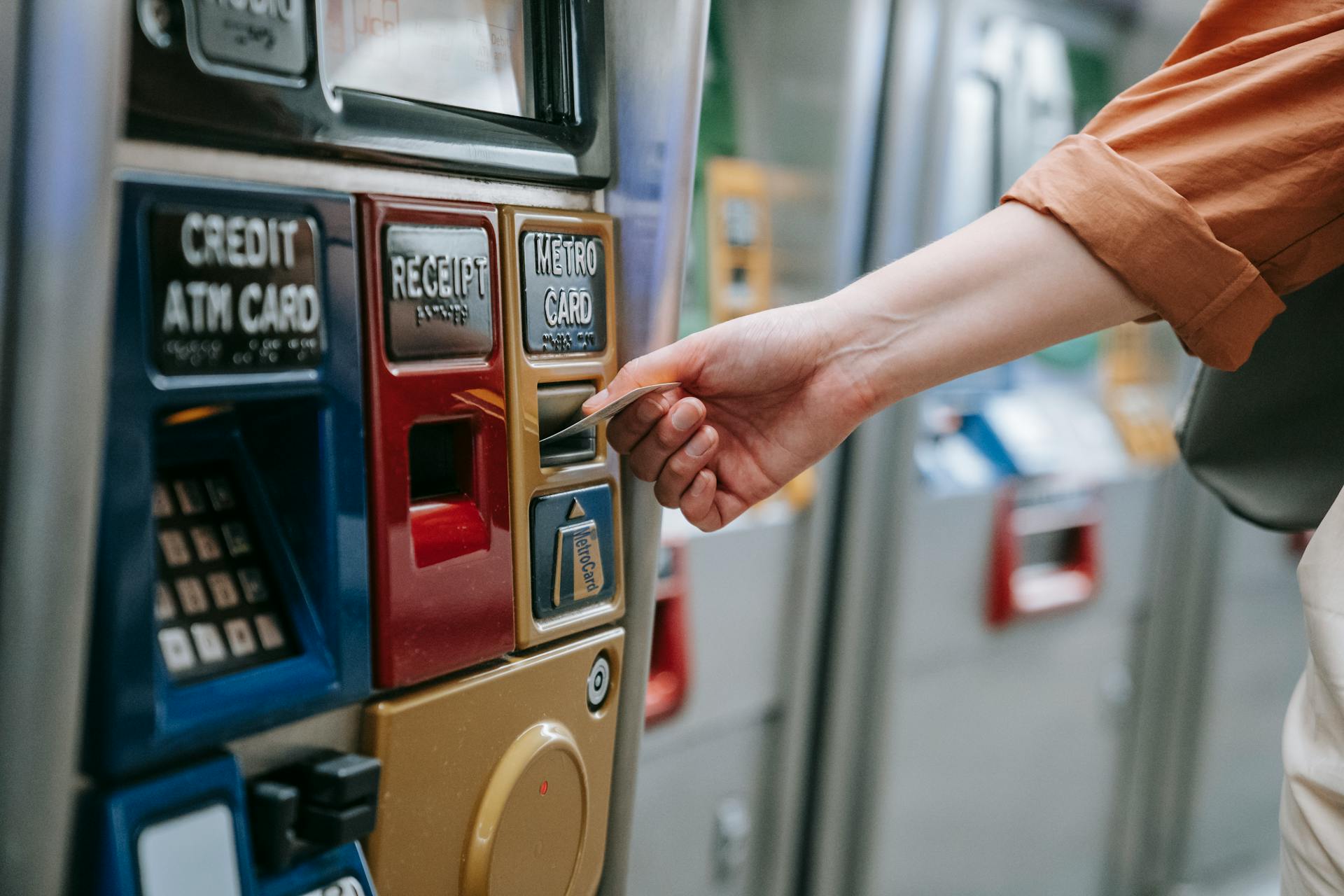 Person Inserting Card on an Automated Machine