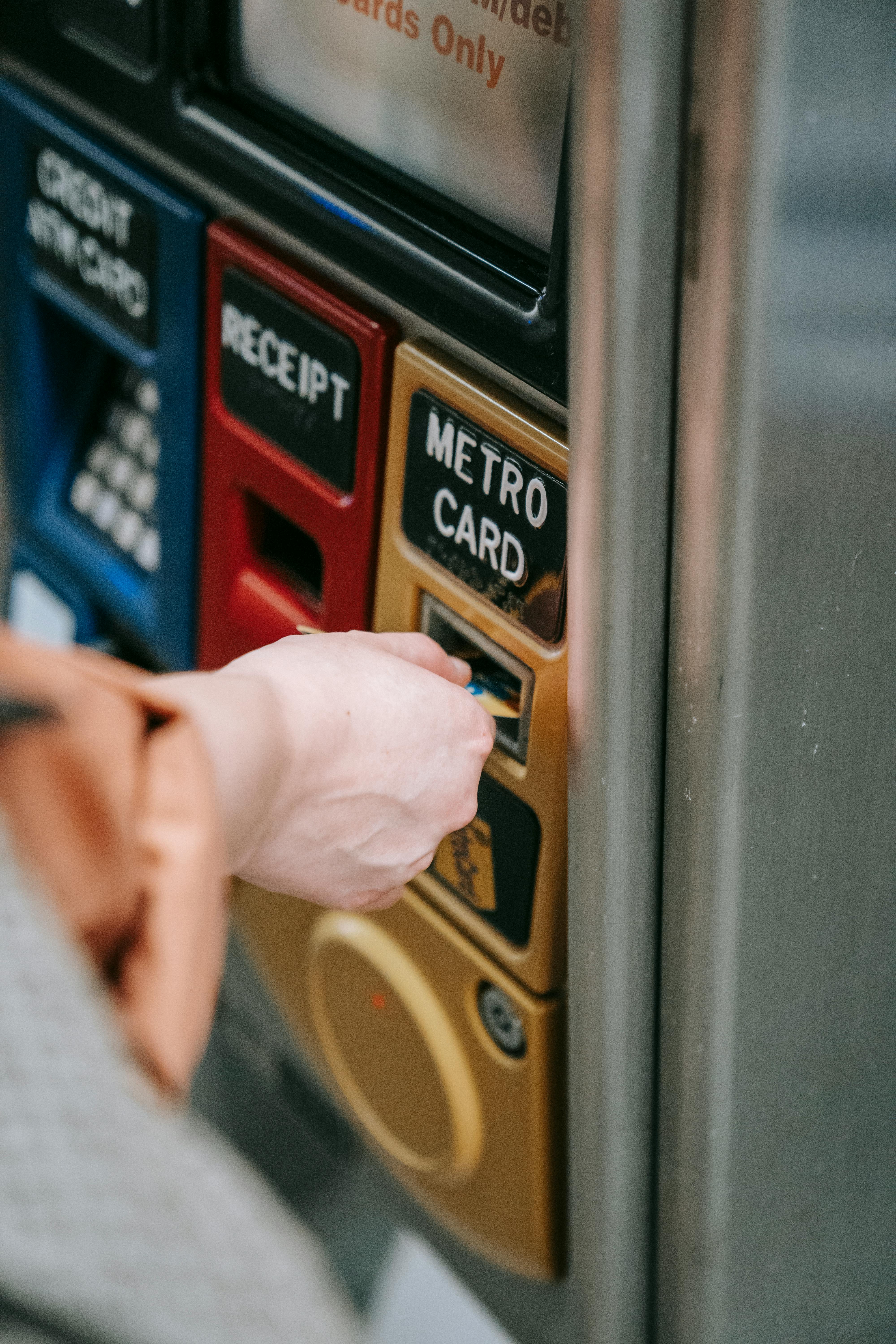 person inserting card on an automated machine