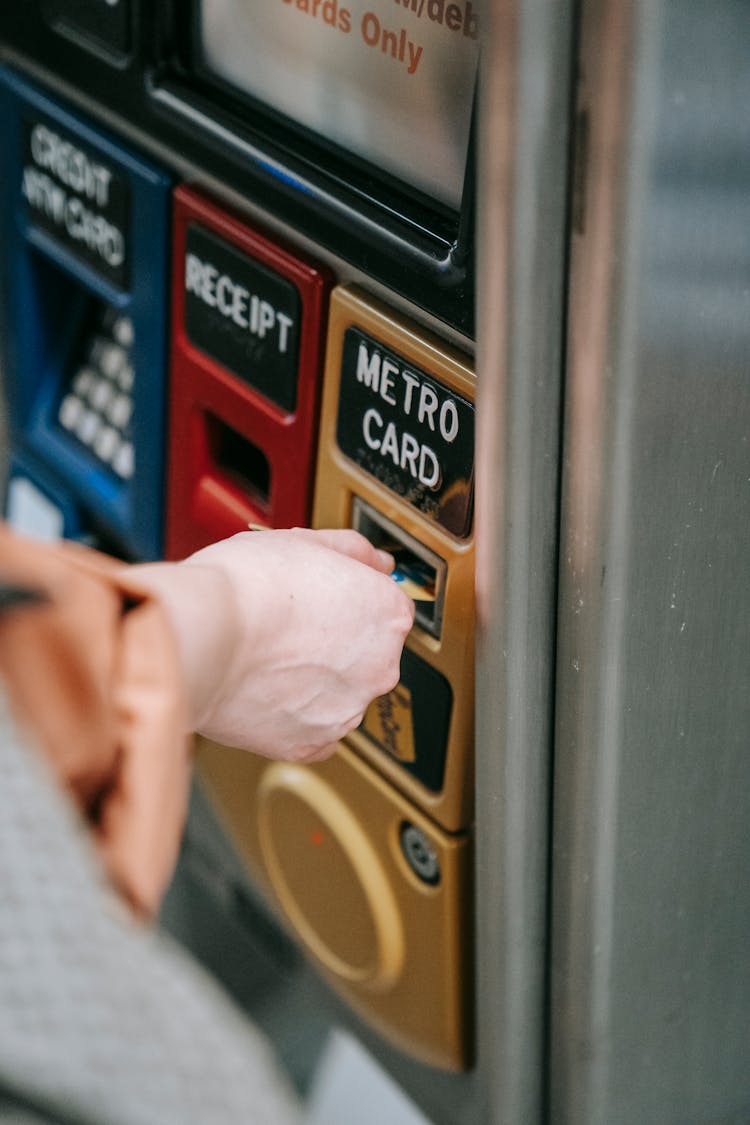 Person Inserting Card On An Automated Machine