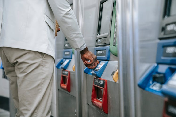 Close-up Of Man Buying A Ticket At A Subway Station 