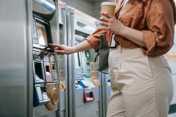 Close-up Of Woman Buying A Ticket In A Ticket Machine 