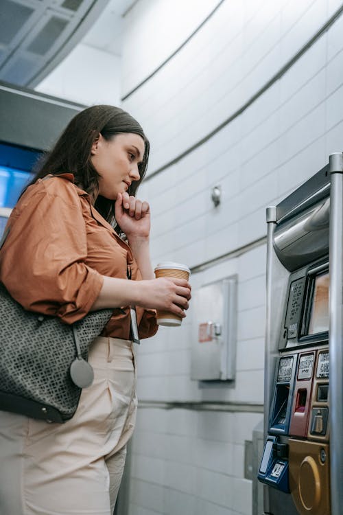 Woman by Ticket Vending Machine