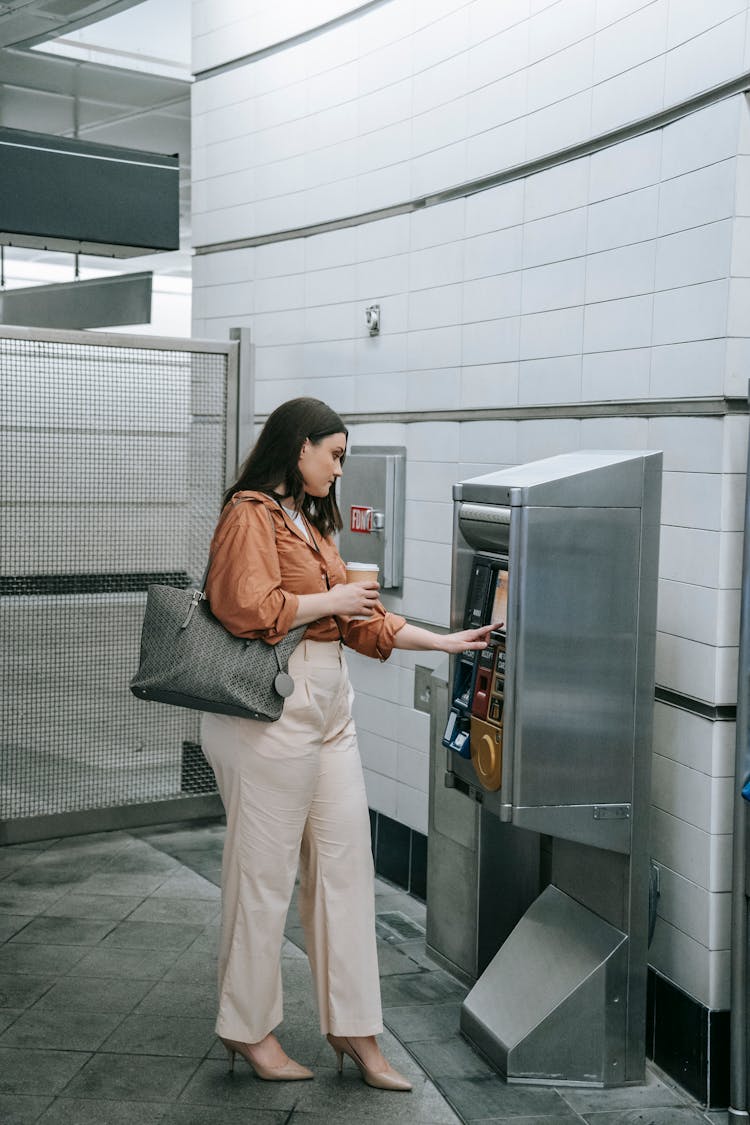 Woman Buying A Ticket In A Ticket Machine 