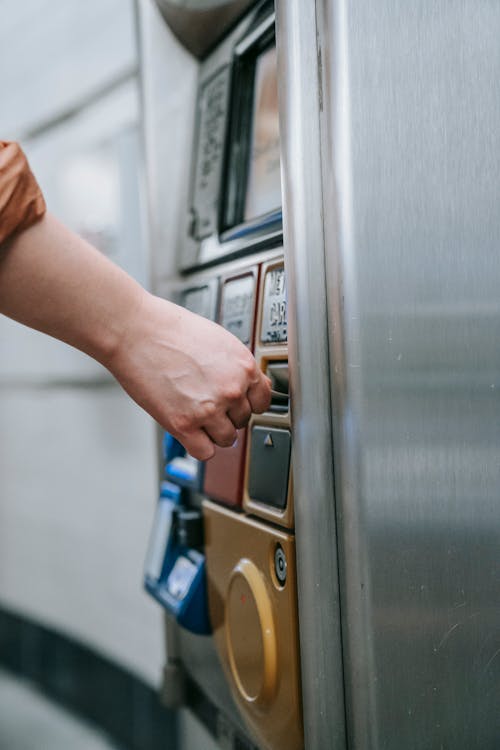 Close-up of a Person Buying a Ticket in a Ticket Machine 