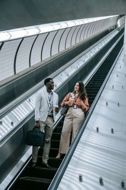 Two People Standing on an Escalator