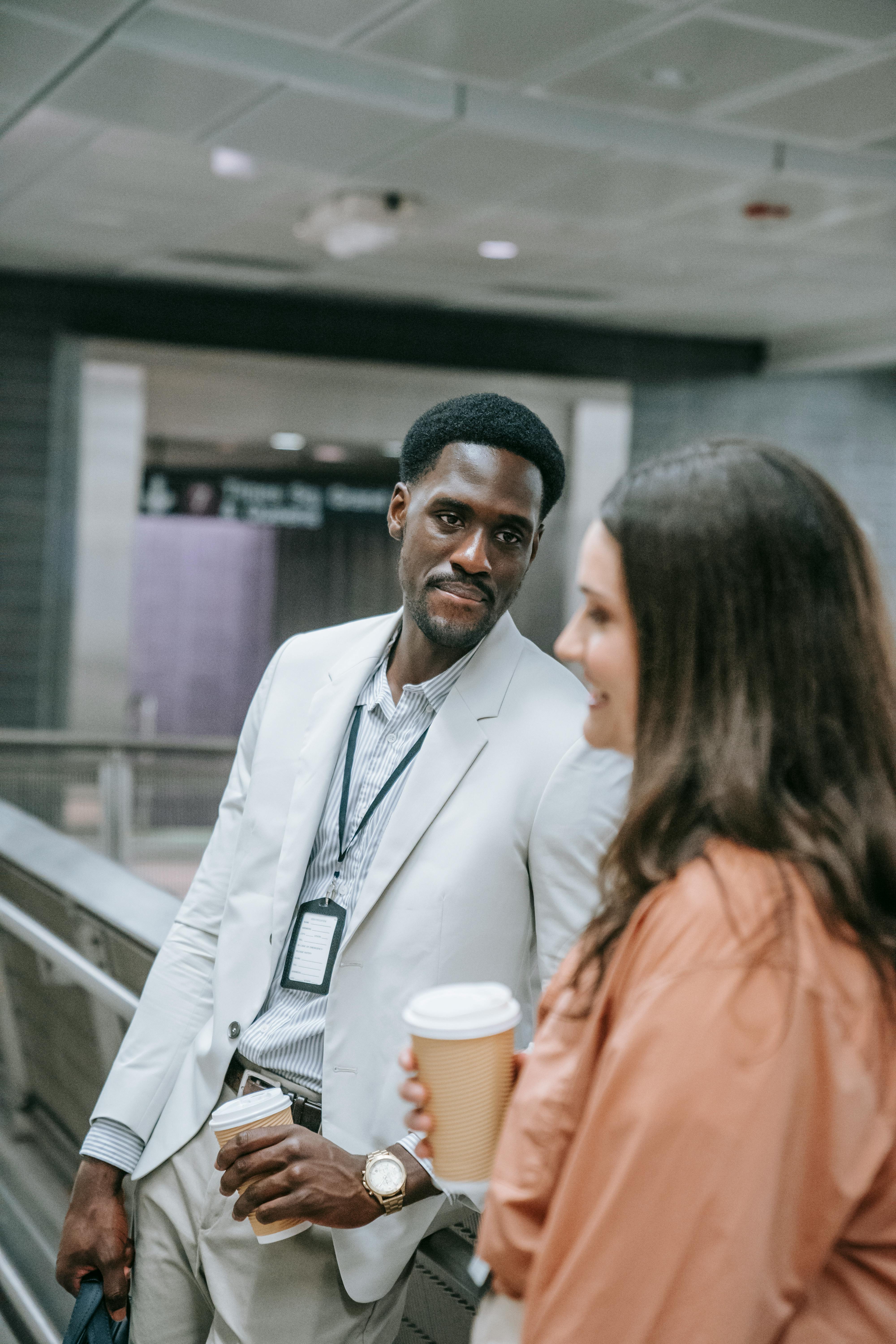 man in gray blazer looking at a woman