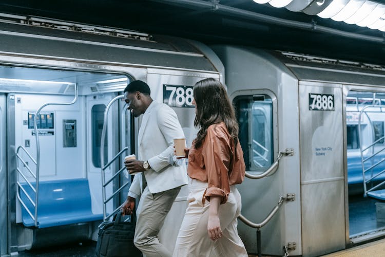 Man And Woman Walking Into A Subway Train 