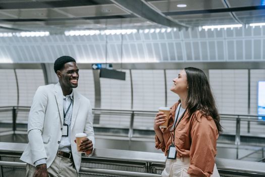 Man in White Dress Shirt Standing Beside Woman in Orange Coat