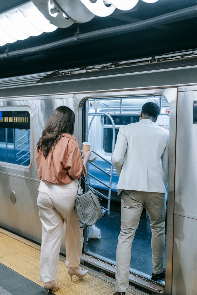 Man And Woman Entering A Train