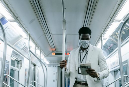 Person Reading Newspaper Inside the Train