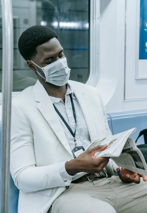 Photo of Man in Suit Jacket Reading Newspaper