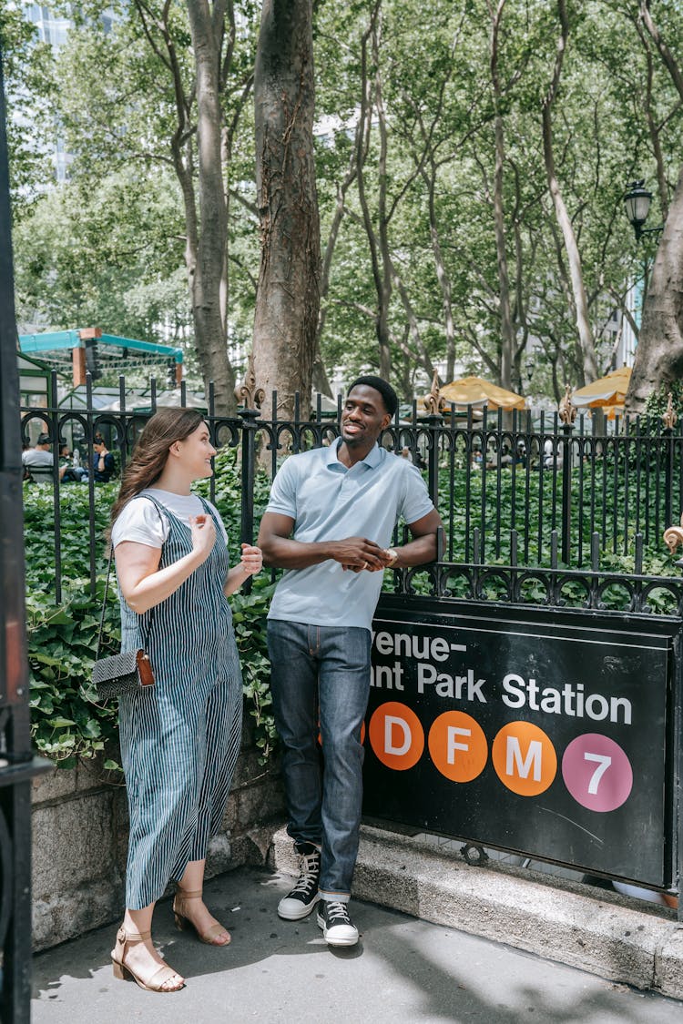 Man And Woman Standing In New York At A Subway Station Entrance 