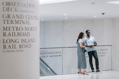 Man and Woman Standing in a Modern Interior in City 