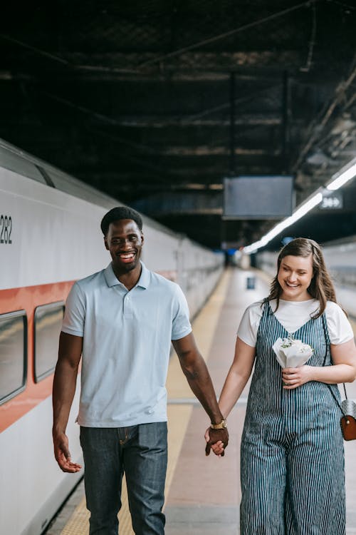 Free Happy Couple Walking at the Train Station Stock Photo