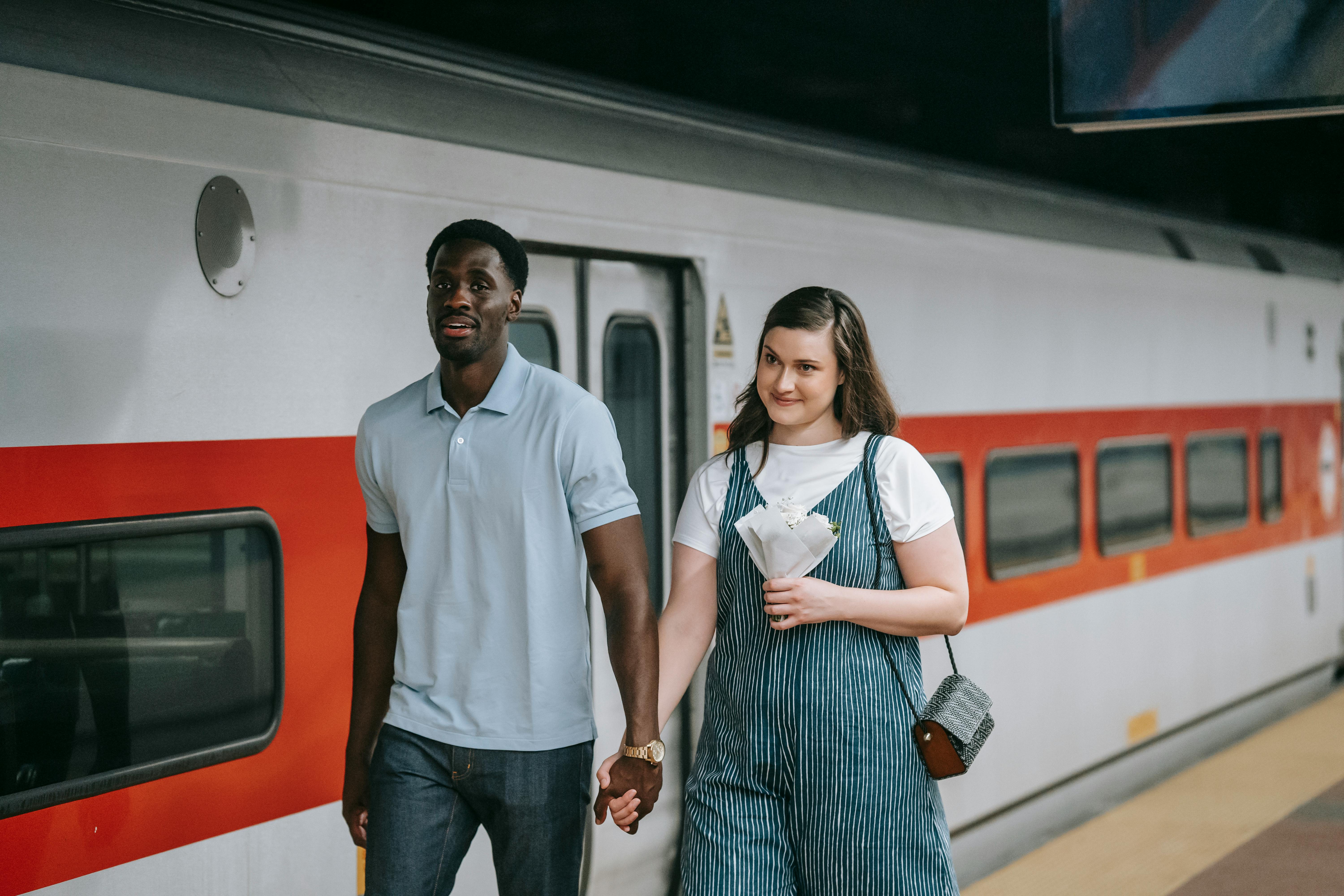 a man holding a woman s hand while walking