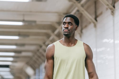 Photo of a Man in Green Tank Top