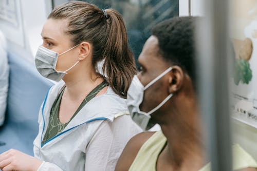 Close Up Photo of Man and Woman Wearing Face Masks