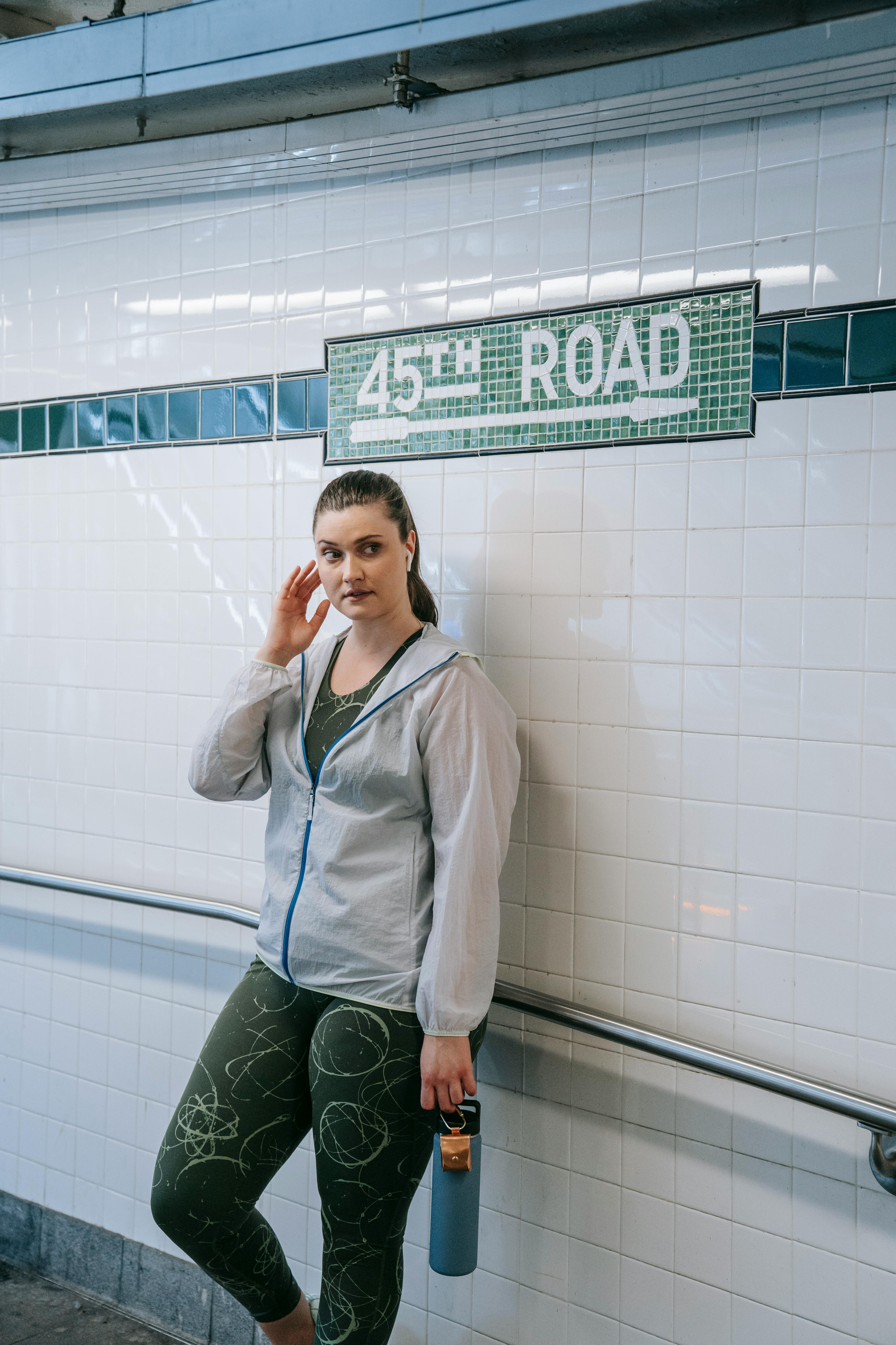 woman standing by directional sign