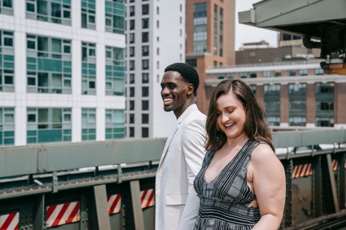 Free Smiling couple enjoying a sunny day outside, capturing urban vibes and happiness. Stock Photo