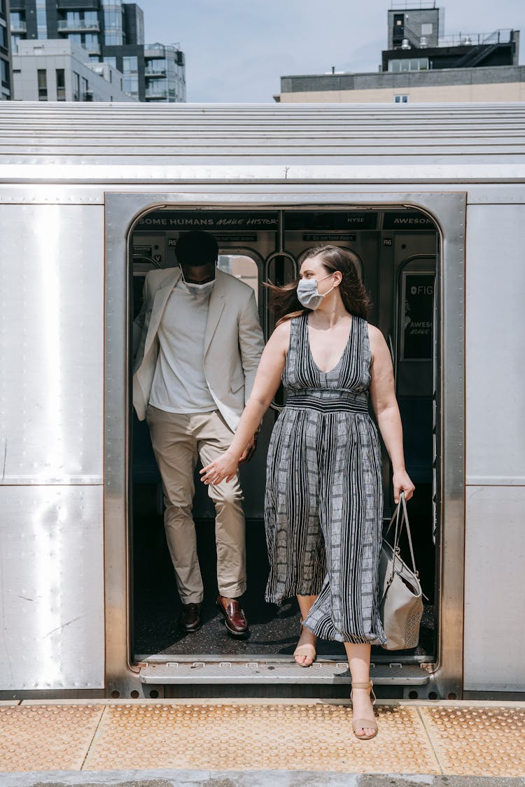 Man And Woman Walking Out From Train