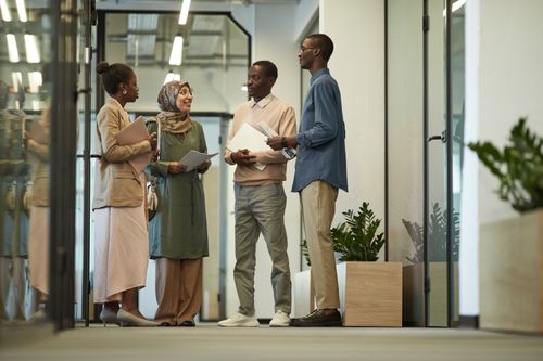 Free Multiracial team collaborating in a modern office environment. Stock Photo