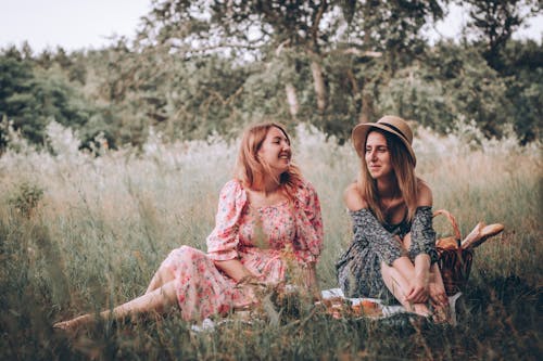 2 Women Sitting on Grass Field on Picnic