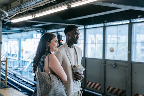 Couple Standing on a Subway Platform 