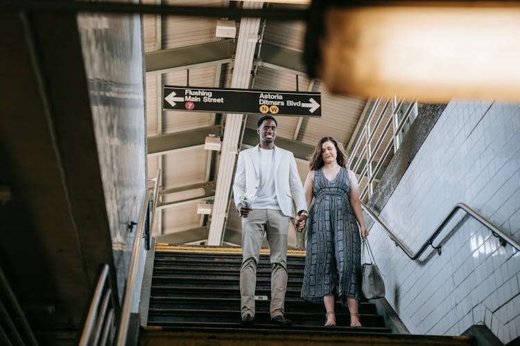 A Couple Walking Down The Stairs