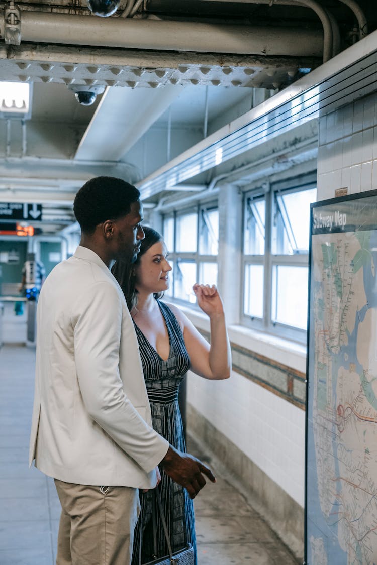 Couple Standing Beside A Subway Map