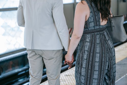 Close Up Photo of Couple Holding Hands
